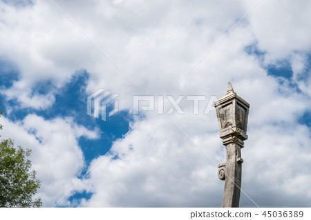 Wooden lantern sculpture and cloudy sky 45036389