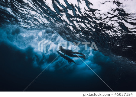 Surfer man with surfboard dive underwater Surfer man with surfboard dive underwater 45037184