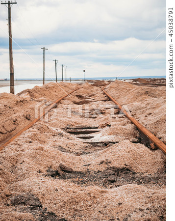 Rusty razy rails rotten sleepers covered salt lake Rusty razy rails rotten sleepers covered salt lake 45038791