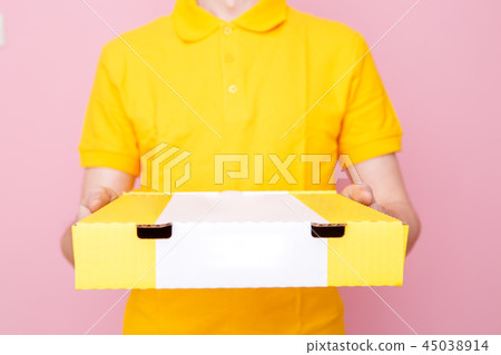 Photo of courier in yellow T-shirt with box with pizza Photo of courier in yellow T-shirt with box with pizza 45038914