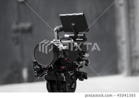 Professional cinema digital video camera on a tripod. Professional cinema digital video camera on a tripod. 45041393
