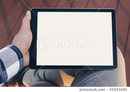 Mockup tablet screen, Man using tablet computer while Stand relax with Clipping path on screen for 45041690