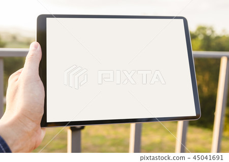 Mockup tablet, Man using tablet computer while Stand relax with Clipping path on screen for easy 45041691