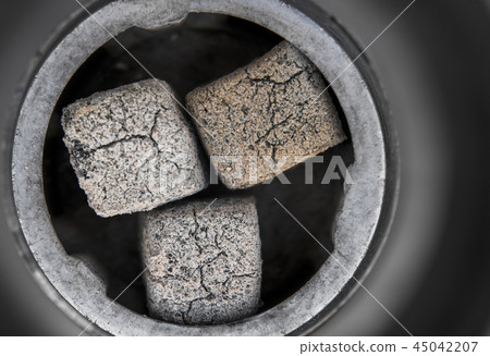 Close-up of a top of hookah with coconut coal. Close-up of a top of hookah with coconut coal. 45042207