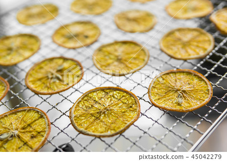 Candied orange slices on grid for drying. Dried fruits which can be used as a decoration to the meal 45042279