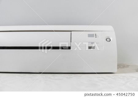 White air conditioner system on white wall in a room. 45042750