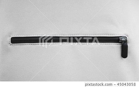 Close up view of the black zipper on grey eco leather material. 45043058