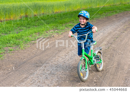 boy on bicycle in rural landscape 45044668