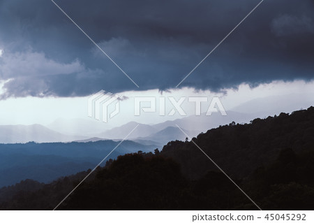 Overlapping mountains with cloudy and rain Overlapping mountains with cloudy and rain 45045292
