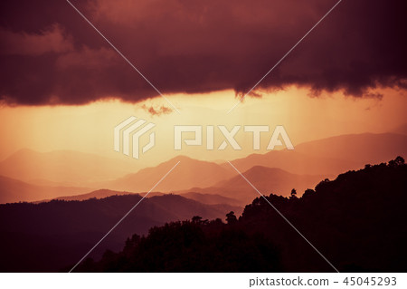 Overlapping mountains with cloudy and rain 45045293