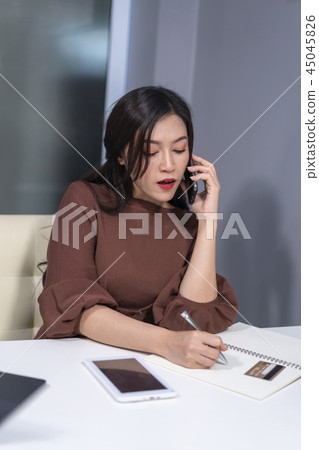woman calling by phone and holdind credit card to online shoppin 45045826