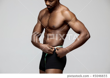 Fit young man with beautiful torso isolated on white background Fit young man with beautiful torso isolated on white background 45046655