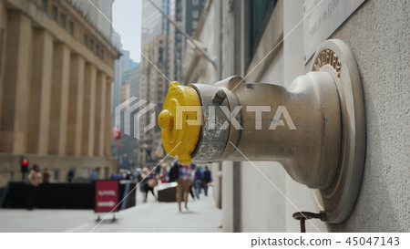 Fire hydrant in the wall of a building on Wall Street in New York 45047143