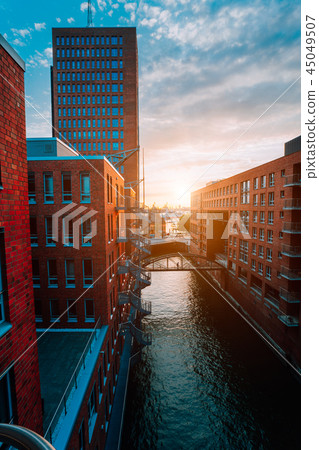 HafenCity. Bridge over canal and red brick buildings in the old warehouse district Speicherstadt in 45049507