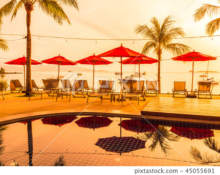 Umbrella and chair around outdoor swimming pool in hotel and resort 45055691