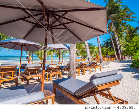 Umbrella and chair on the beach and sea ocean with blue sky Umbrella and chair on the beach and sea ocean with blue sky 45055693