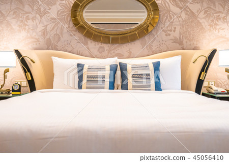 Comfotable pillow on bed with light lamp decoration Comfotable pillow on bed with light lamp decoration 45056410