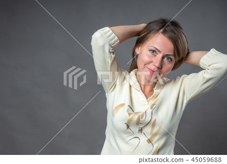 Woman emotion. The young woman gathered her hair 45059688