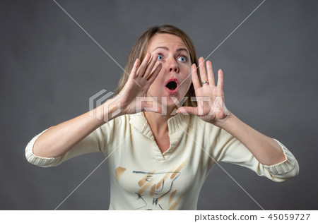 Woman emotion. Young woman yells out loud to 45059727