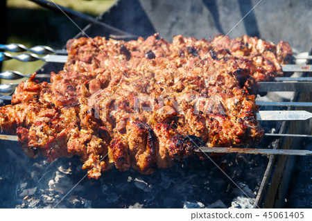 Grilled kebab cooking on metal skewer Grilled kebab cooking on metal skewer 45061405