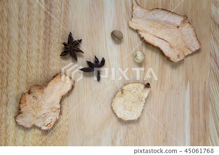 Star anise spices and dried ginger on wooden desk Star anise spices and dried ginger on wooden desk 45061768