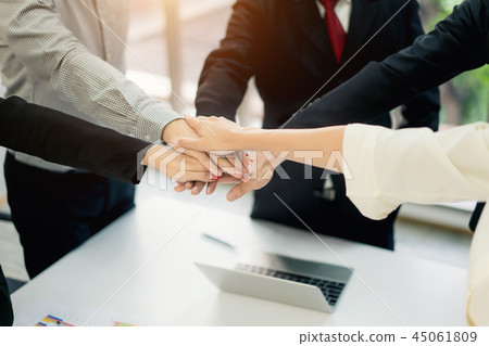 business people putting their hands together 45061809