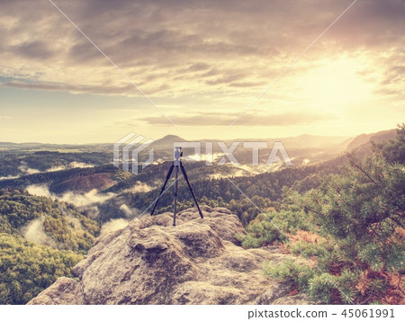 Mountain landscape with tripod in ready on edge. Mountain landscape with tripod in ready on edge. 45061991