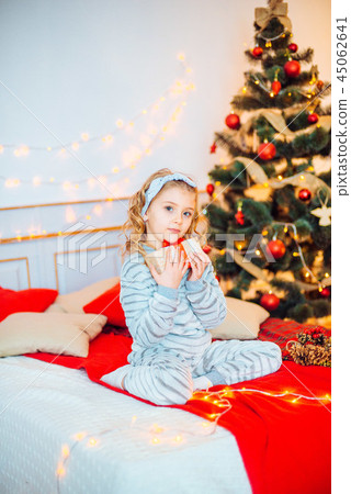 Little girl in pajamas at Christmas morning Little girl in pajamas at Christmas morning 45062641