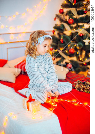 Little girl in pajamas at Christmas morning Little girl in pajamas at Christmas morning 45062644