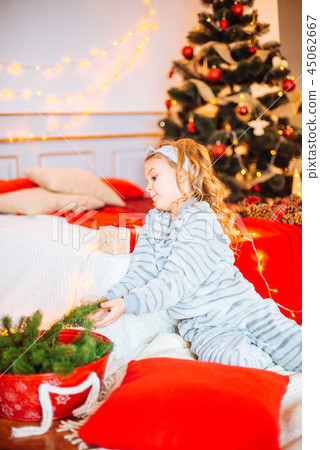 Little girl in pajamas at Christmas morning Little girl in pajamas at Christmas morning 45062667