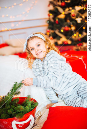 Little girl in pajamas at Christmas morning Little girl in pajamas at Christmas morning 45062672