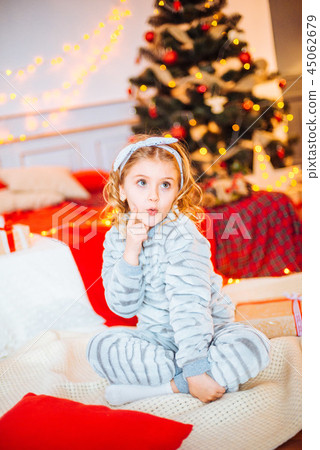 Little girl in pajamas at Christmas morning Little girl in pajamas at Christmas morning 45062679