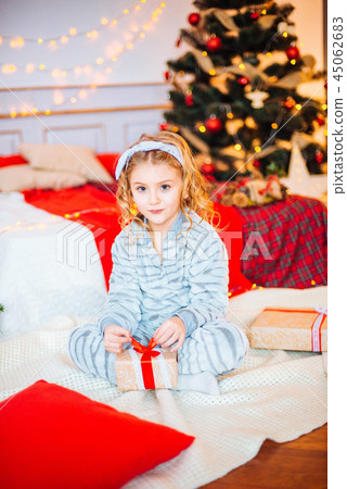 Little girl in pajamas at Christmas morning Little girl in pajamas at Christmas morning 45062683