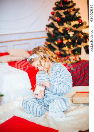 Little girl in pajamas at Christmas morning Little girl in pajamas at Christmas morning 45062685