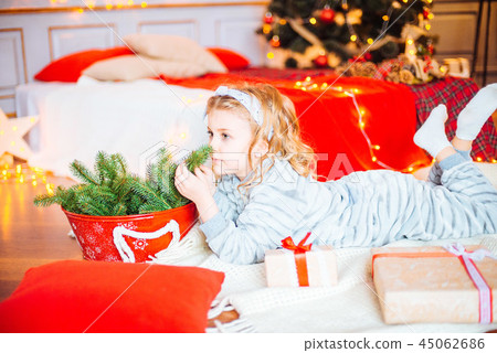 Little girl in pajamas at Christmas morning Little girl in pajamas at Christmas morning 45062686