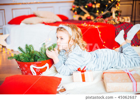 Little girl in pajamas at Christmas morning Little girl in pajamas at Christmas morning 45062687
