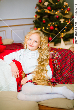 Little girl with long hair at Christmas morning Little girl with long hair at Christmas morning 45063751