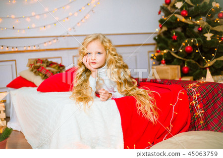 Little girl with long hair at Christmas morning Little girl with long hair at Christmas morning 45063759