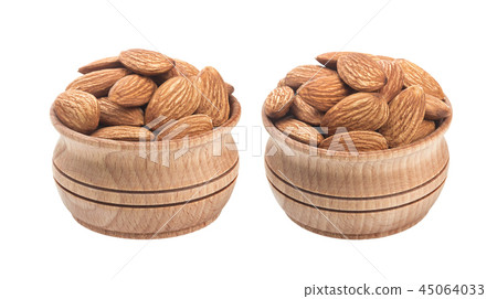 Almond nut in wooden bowl isolated on a white background Almond nut in wooden bowl isolated on a white background 45064033