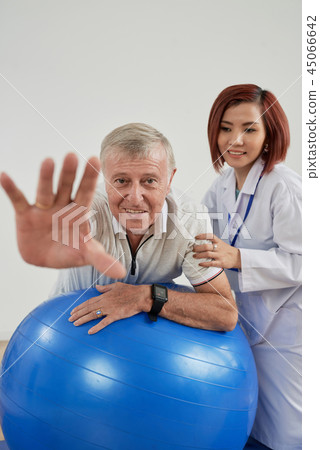 Aged man exercising on fitball Aged man exercising on fitball 45066642