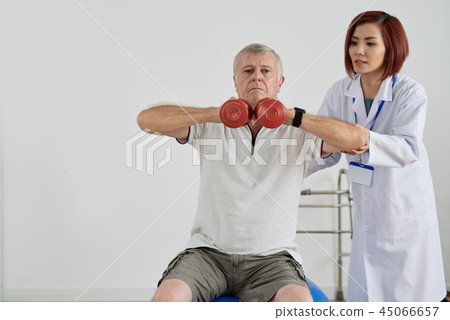 Aged man exercising with dumbbells 45066657
