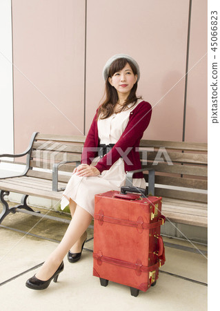 A woman sitting on a bench 45066823