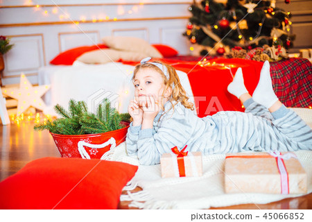 Little girl in pajamas at Christmas morning Little girl in pajamas at Christmas morning 45066852
