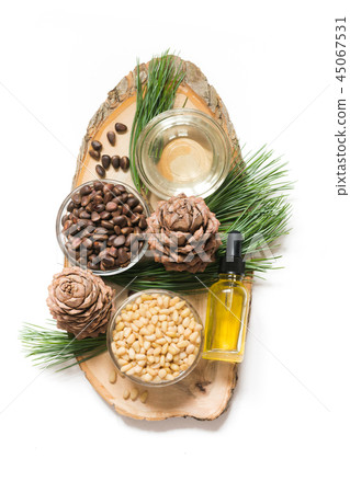 Cedar oil, branches and cedar cone on white. Cedar oil, branches and cedar cone on white. 45067531