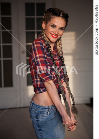 female mechanic in the garage with long braids with 45068968