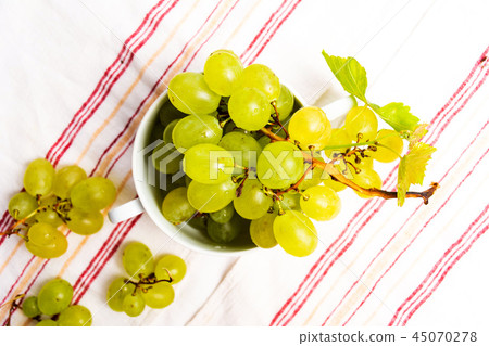 Green grapes in a white bowl top view Green grapes in a white bowl top view 45070278