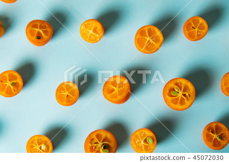 Kumquat fruit slices on blue background 45072030