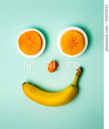 Smiley face made of healthy fruits, top view 45072031