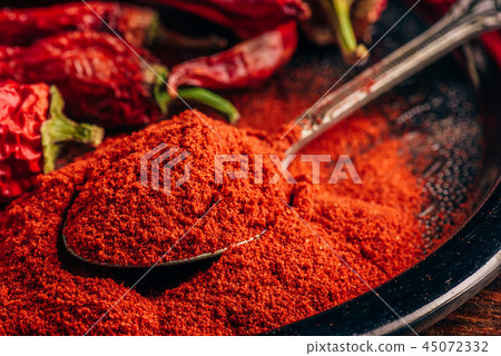 Spoonful of ground red chili pepper Spoonful of ground red chili pepper 45072332