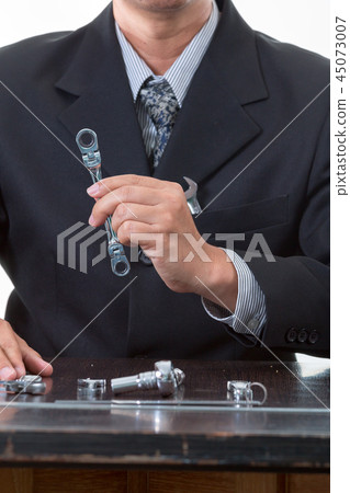 Chief mechanical engineer holding many tools Chief mechanical engineer holding many tools 45073007
